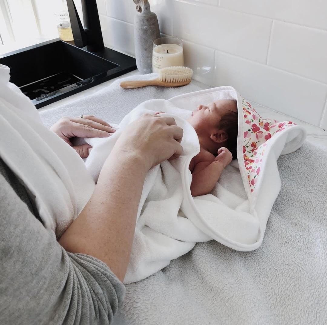 @handful.of.adventures using our Apron Style Baby Bath Towel